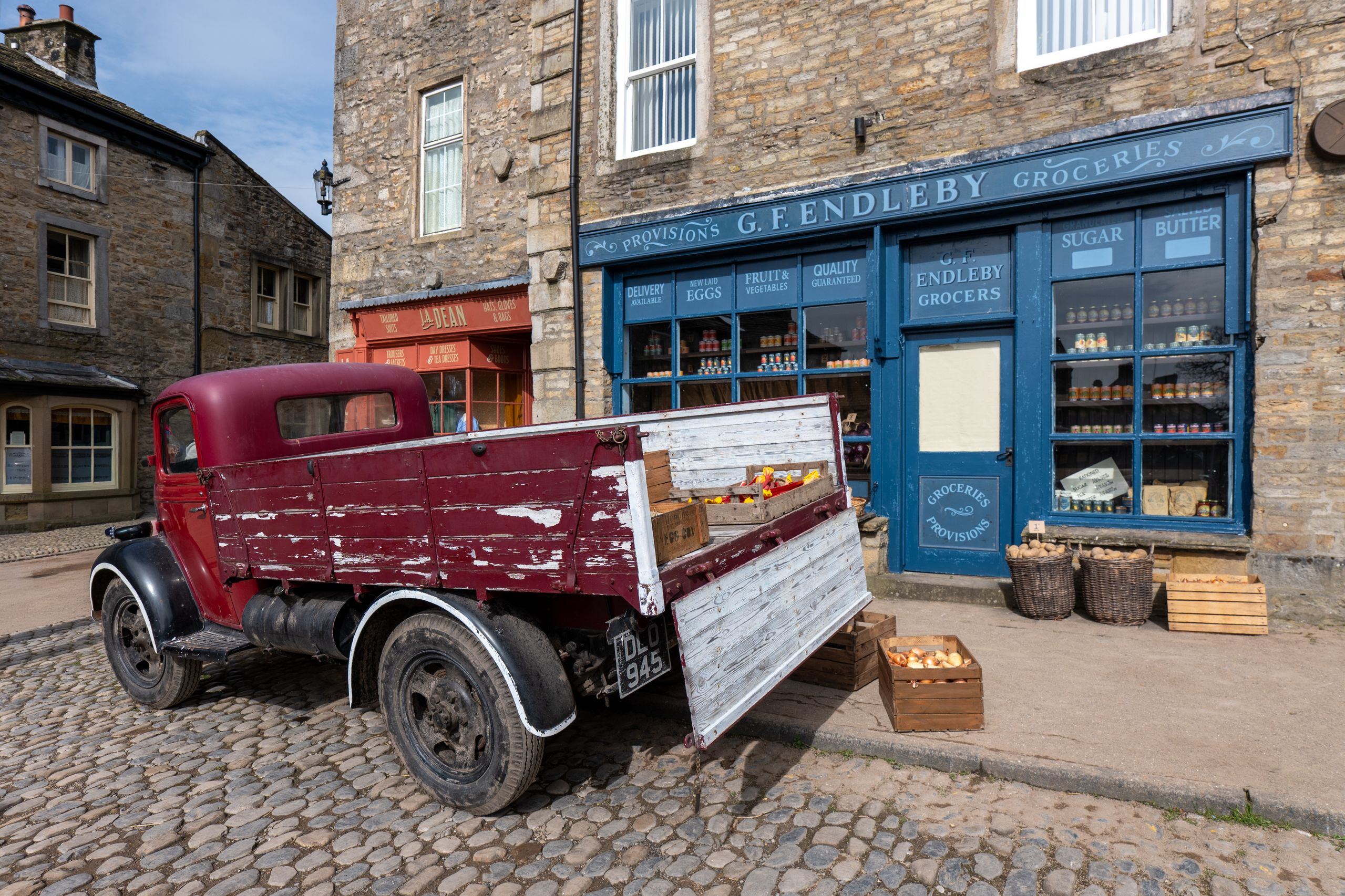Sketch illustration of stone storefront with sign Stonebridge Cheese and Provisions
