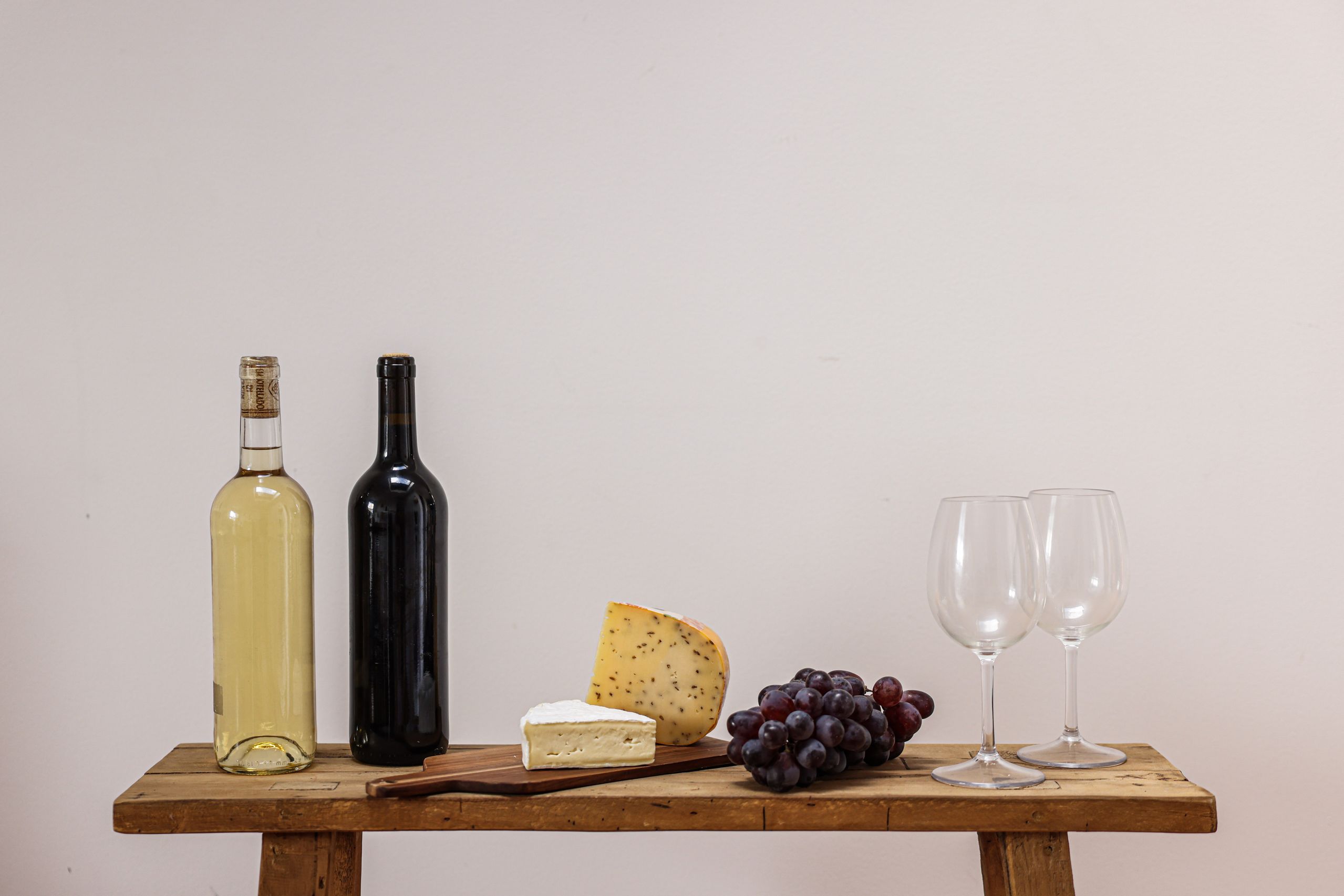 Cheese board with grapes and wine